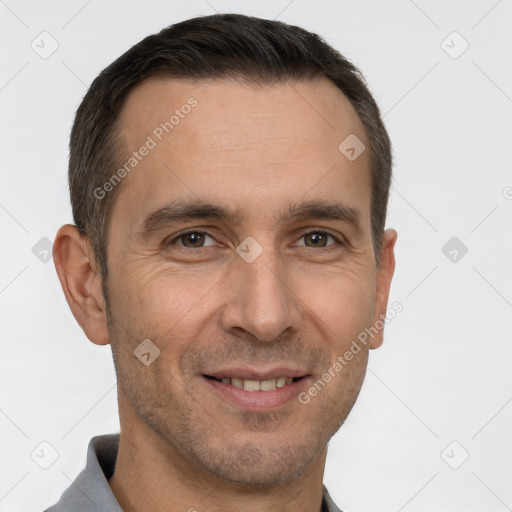 Joyful white adult male with short  brown hair and brown eyes