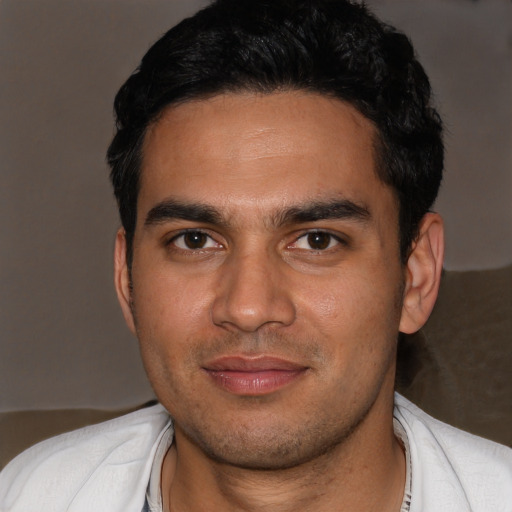 Joyful white young-adult male with short  black hair and brown eyes