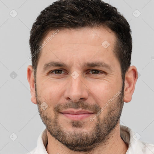 Joyful white adult male with short  brown hair and brown eyes