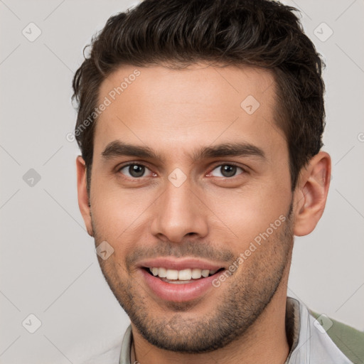 Joyful white young-adult male with short  brown hair and brown eyes