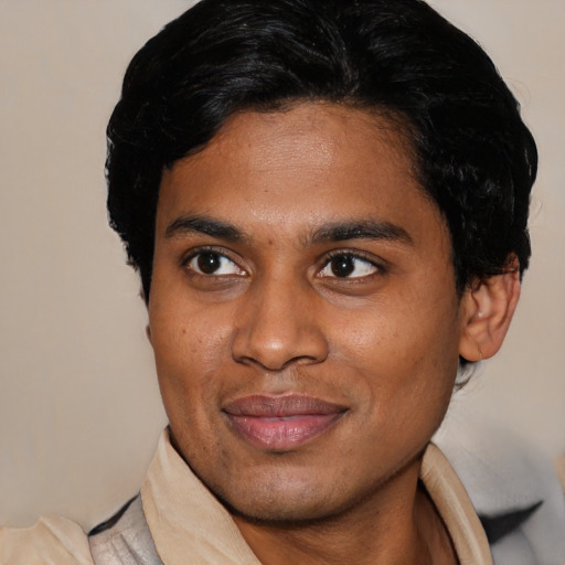 Joyful latino young-adult male with short  brown hair and brown eyes