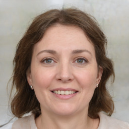 Joyful white adult female with medium  brown hair and grey eyes