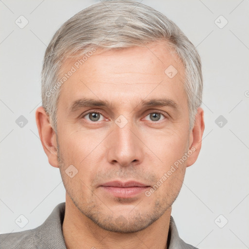 Neutral white adult male with short  gray hair and grey eyes