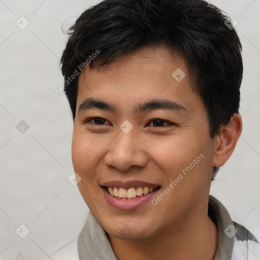 Joyful asian young-adult male with short  brown hair and brown eyes