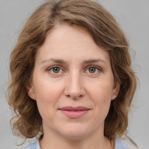 Joyful white young-adult female with medium  brown hair and green eyes