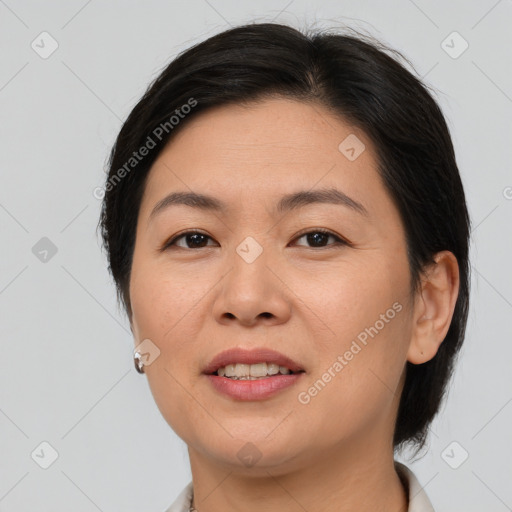 Joyful asian adult female with medium  brown hair and brown eyes