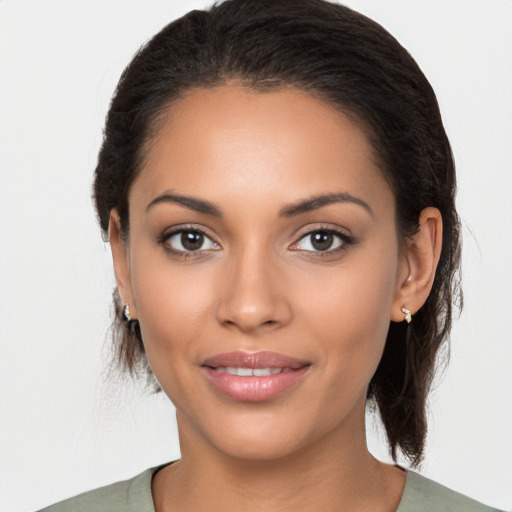 Joyful latino young-adult female with medium  brown hair and brown eyes