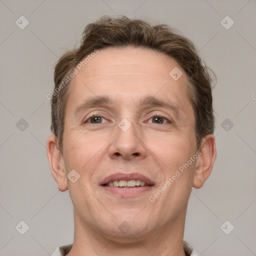 Joyful white adult male with short  brown hair and brown eyes