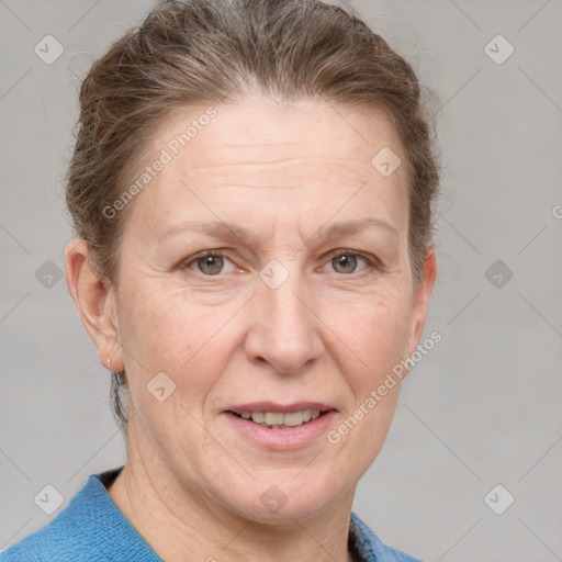 Joyful white adult female with medium  brown hair and blue eyes