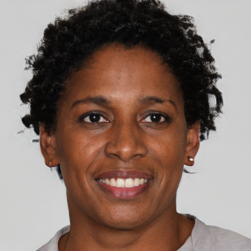 Joyful black adult female with short  brown hair and brown eyes