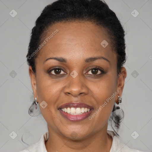 Joyful black adult female with medium  brown hair and brown eyes