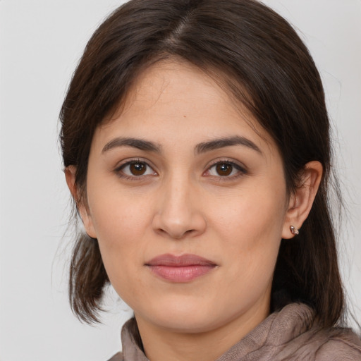 Joyful white young-adult female with medium  brown hair and brown eyes