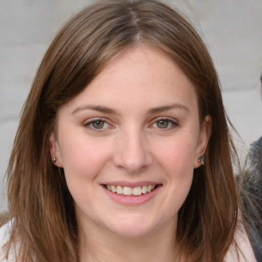 Joyful white young-adult female with long  brown hair and grey eyes