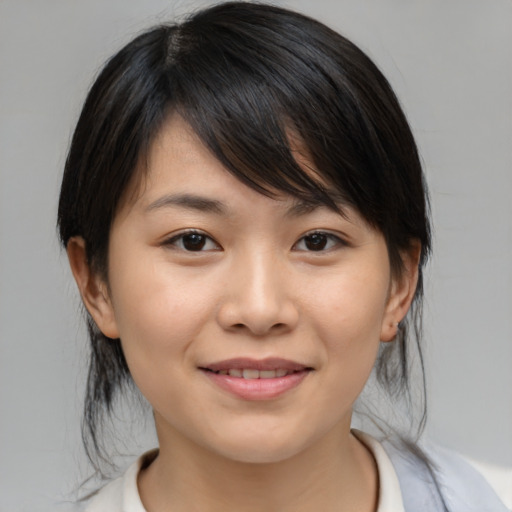 Joyful asian young-adult female with medium  brown hair and brown eyes