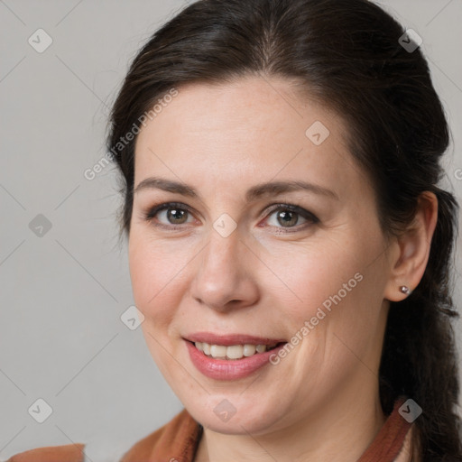 Joyful white adult female with medium  brown hair and brown eyes