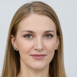 Joyful white young-adult female with long  brown hair and green eyes