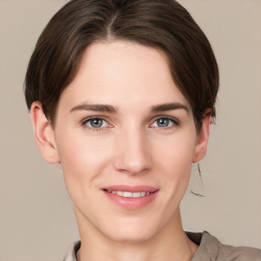 Joyful white young-adult female with short  brown hair and grey eyes