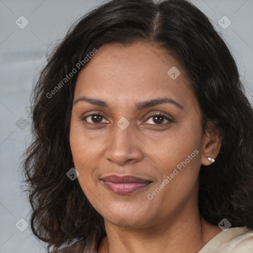 Joyful white adult female with long  brown hair and brown eyes