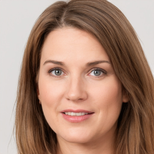 Joyful white young-adult female with long  brown hair and grey eyes