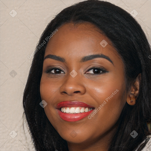 Joyful black young-adult female with long  black hair and brown eyes