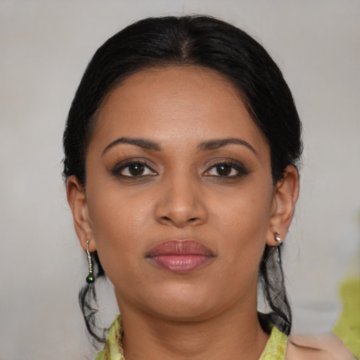 Joyful black young-adult female with medium  brown hair and brown eyes