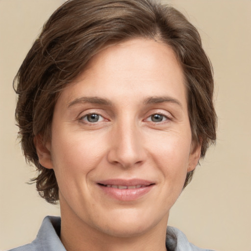 Joyful white adult female with short  brown hair and grey eyes