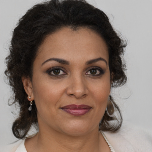 Joyful black adult female with medium  brown hair and brown eyes