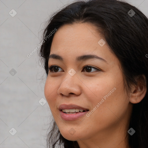 Joyful asian young-adult female with long  brown hair and brown eyes