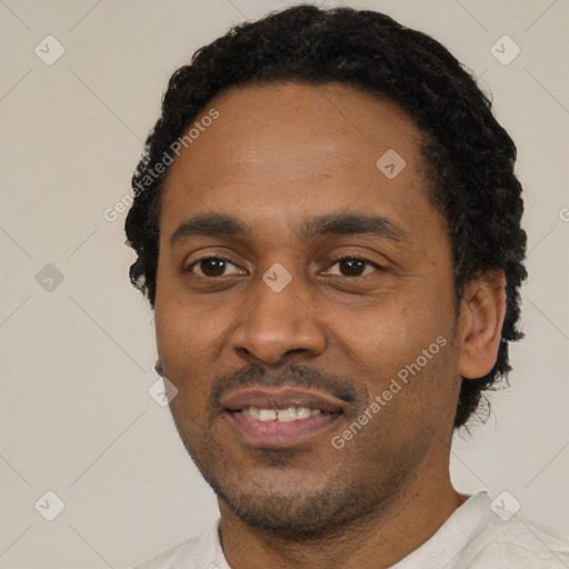 Joyful latino adult male with short  black hair and brown eyes
