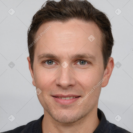 Joyful white adult male with short  brown hair and grey eyes