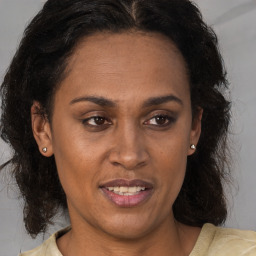 Joyful black adult female with medium  brown hair and brown eyes