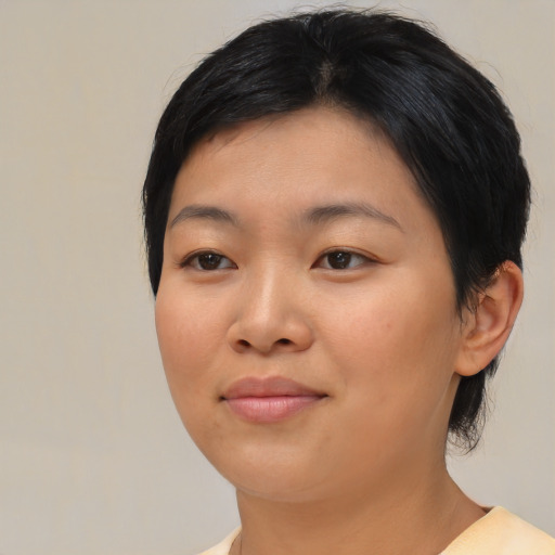 Joyful asian young-adult female with medium  black hair and brown eyes