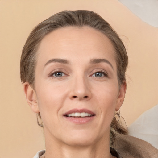 Joyful white adult female with medium  brown hair and brown eyes