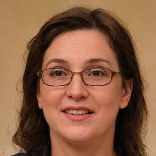 Joyful white adult female with long  brown hair and green eyes