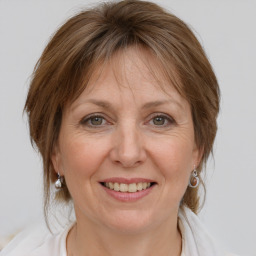 Joyful white adult female with medium  brown hair and grey eyes