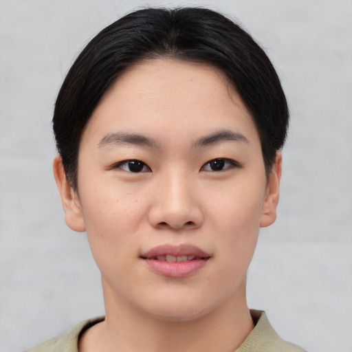 Joyful asian young-adult female with short  black hair and brown eyes