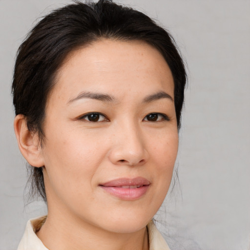 Joyful asian young-adult female with medium  brown hair and brown eyes