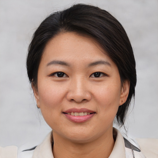 Joyful asian young-adult female with medium  brown hair and brown eyes
