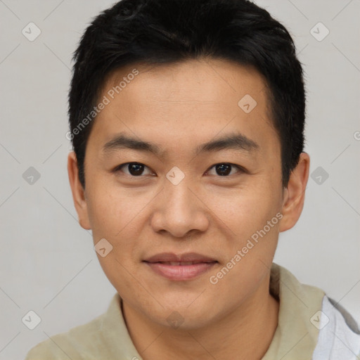 Joyful asian young-adult male with short  black hair and brown eyes