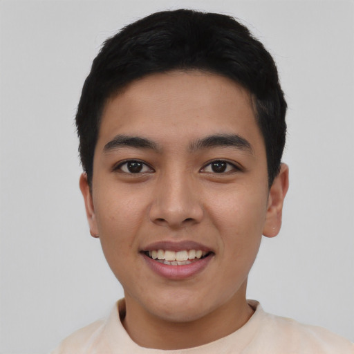 Joyful asian young-adult male with short  black hair and brown eyes