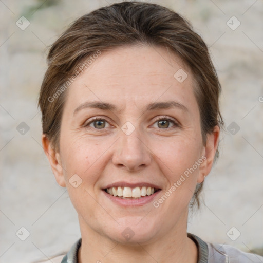 Joyful white adult female with short  brown hair and grey eyes