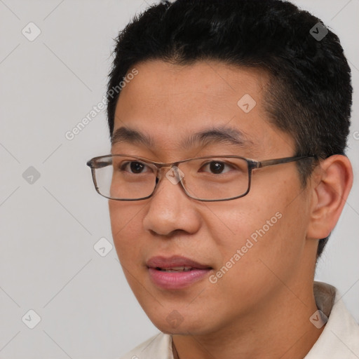 Joyful asian young-adult male with short  brown hair and brown eyes