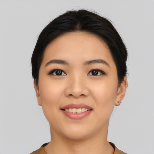 Joyful asian young-adult female with short  black hair and brown eyes