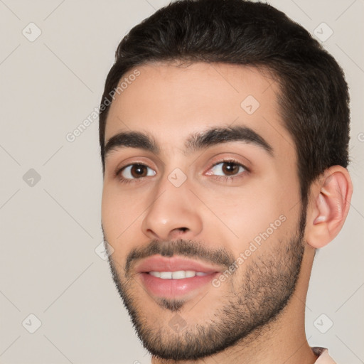 Joyful white young-adult male with short  black hair and brown eyes