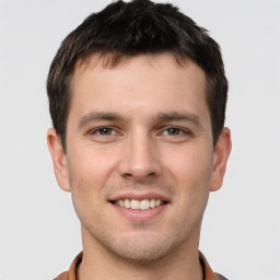 Joyful white young-adult male with short  brown hair and brown eyes