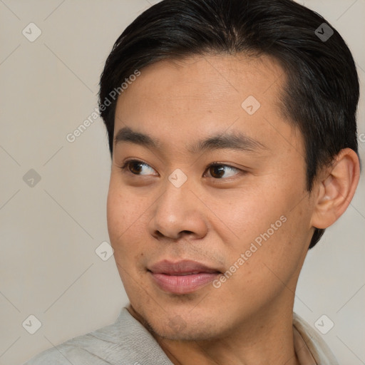 Joyful asian young-adult male with short  brown hair and brown eyes