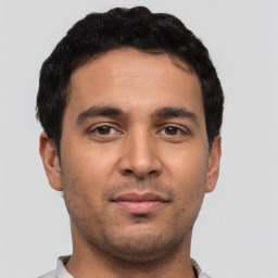 Neutral latino young-adult male with short  black hair and brown eyes