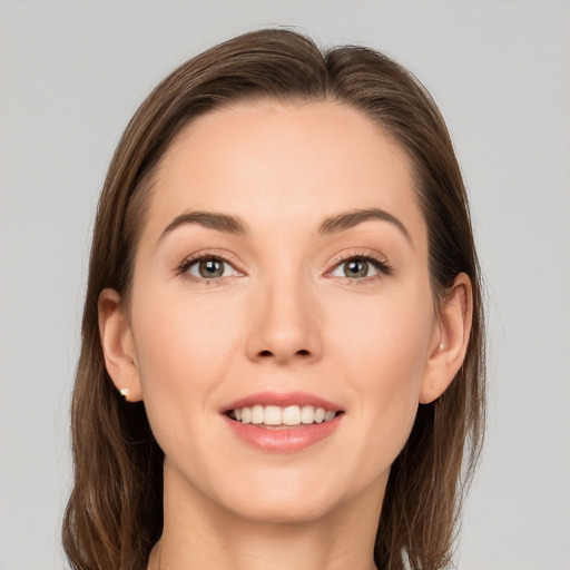 Joyful white young-adult female with long  brown hair and grey eyes