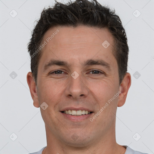 Joyful white adult male with short  brown hair and brown eyes