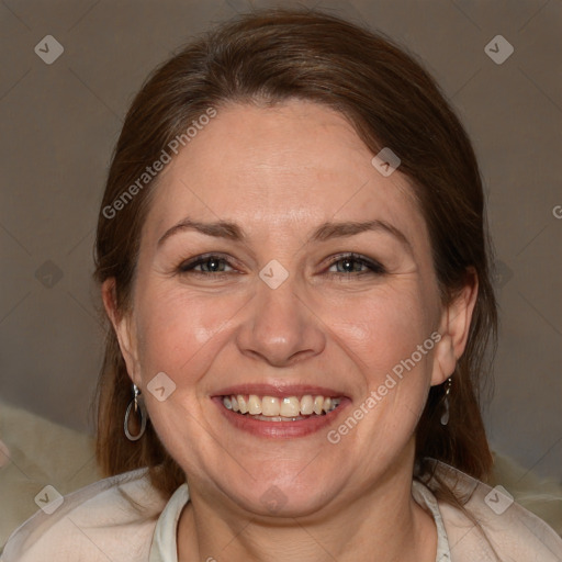 Joyful white adult female with medium  brown hair and brown eyes